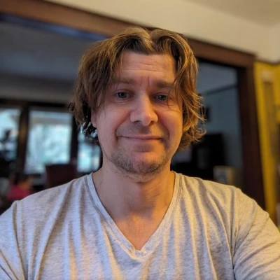 Dude with 5 o-clock shadow and a grey v-neck shirt